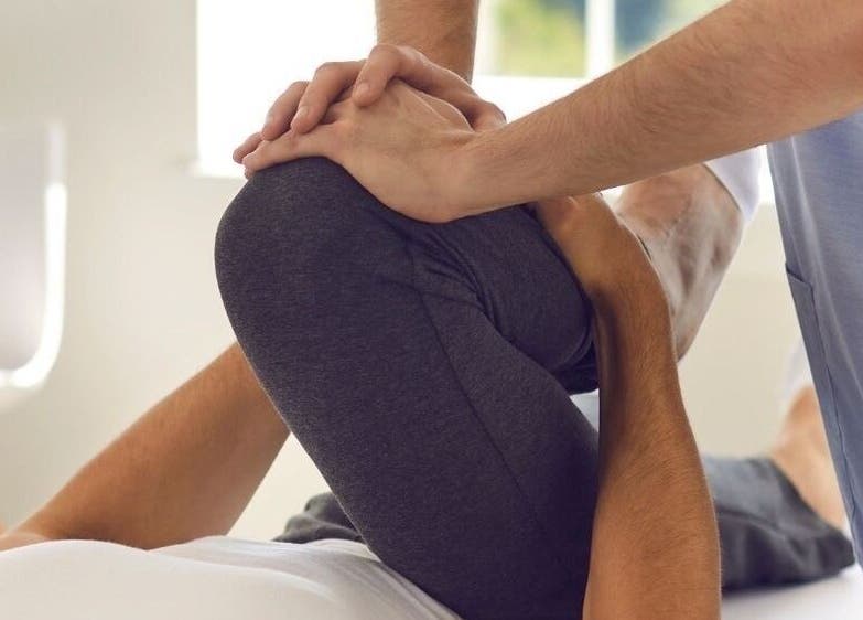 Chiropractor performing leg stretch at Chiro Magic, NYC, New York, US.
