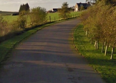 Serene path leading to Beauty on the Hill, Huntly, Scotland, GB, surrounded by lush greenery.