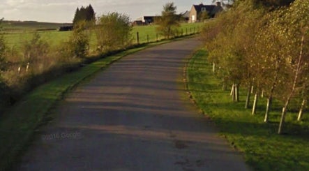 Serene path leading to Beauty on the Hill, Huntly, Scotland, GB, surrounded by lush greenery.