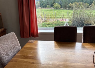 Warm interior view in Beauty on the Hill, Huntly, Scotland, GB with scenic greenery through the window.