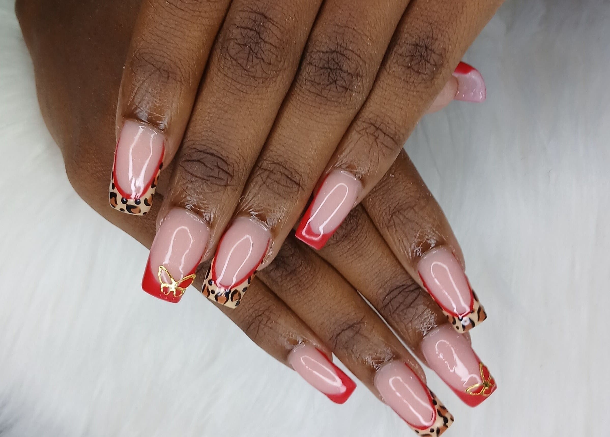 Chic leopard print nails with red tips at Zee's Beauty Studio, Porey Spring, Saint Thomas, BB.