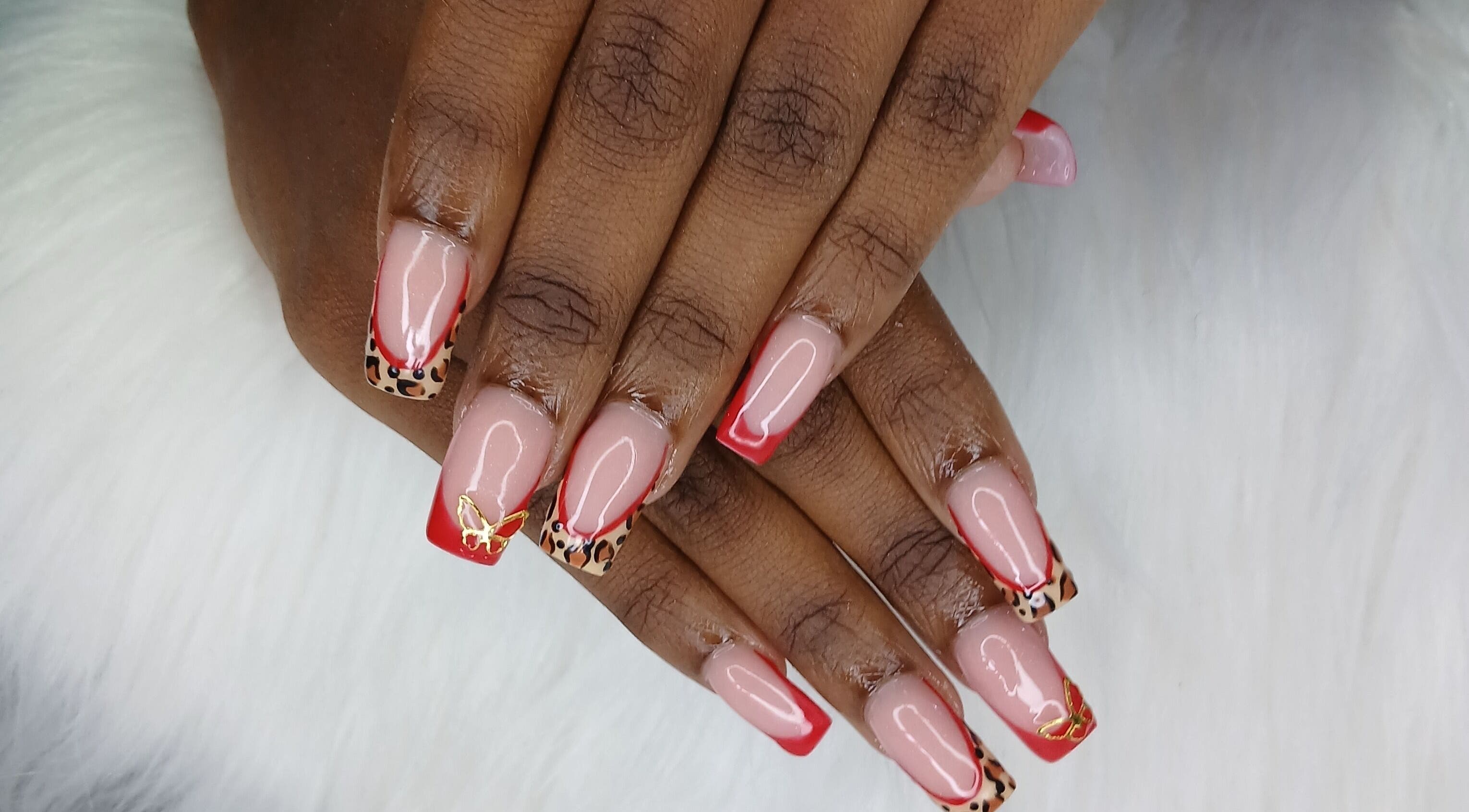Chic leopard print nails with red tips at Zee's Beauty Studio, Porey Spring, Saint Thomas, BB.