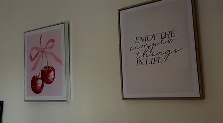 Decorative wall art with cherries and quote at Eves Lash Studio, Portadown, Northern Ireland, GB.