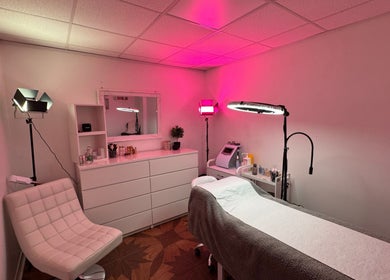 Calm treatment room at Paulina ProBeauty, Shrewsbury, England, GB, with pink ambiance and modern decor.