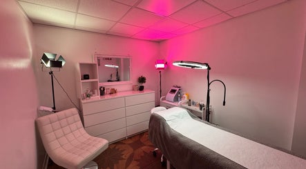 Calm treatment room at Paulina ProBeauty, Shrewsbury, England, GB, with pink ambiance and modern decor.
