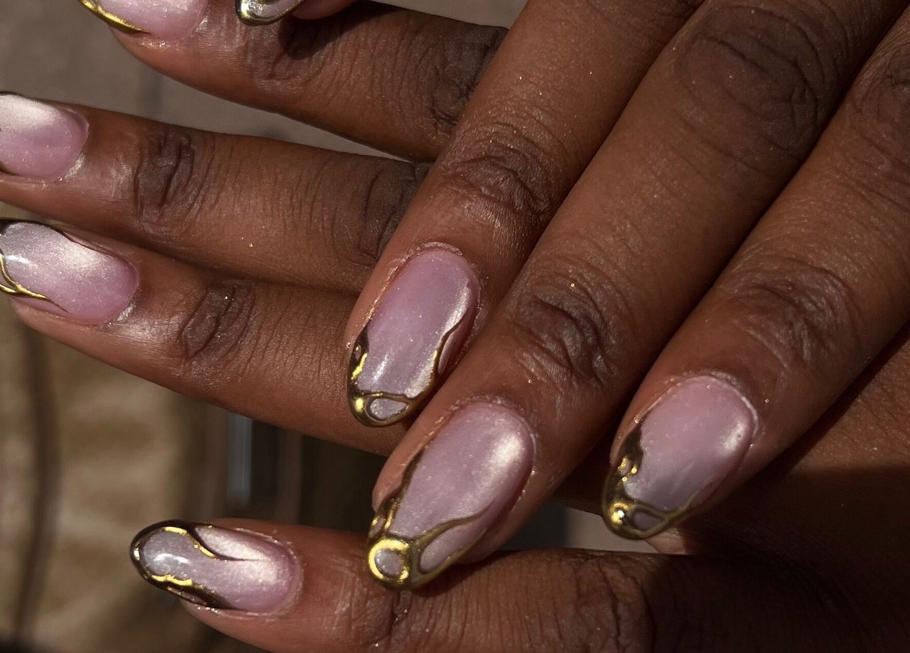 Intricate nail design with gold accents at ChristianShS, Stockport, England, GB.