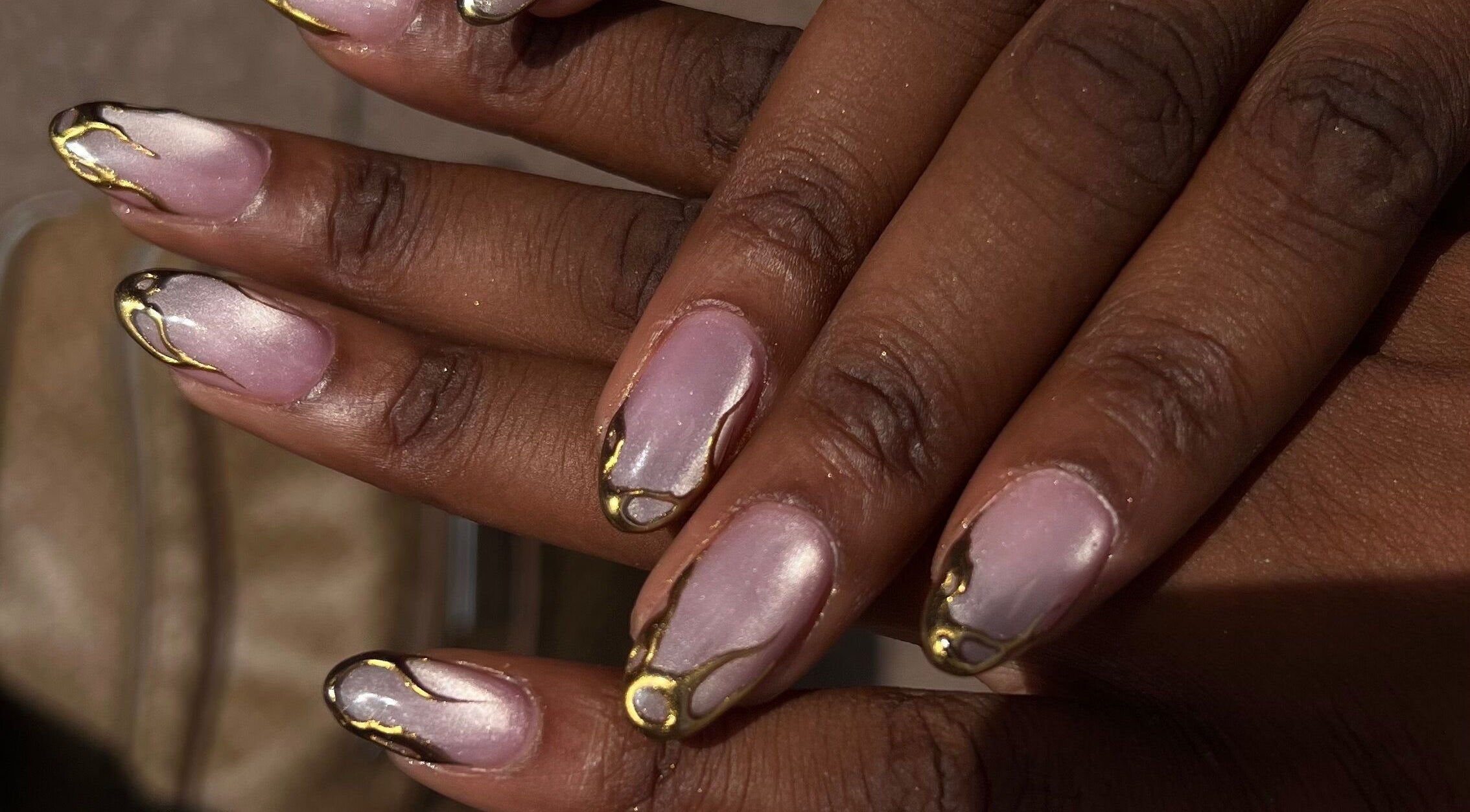 Intricate nail design with gold accents at ChristianShS, Stockport, England, GB.