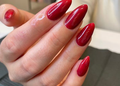 Elegant crimson nail art at Dolluxe Beauty, Aberdeen, Scotland, GB showcasing sophisticated manicure style.