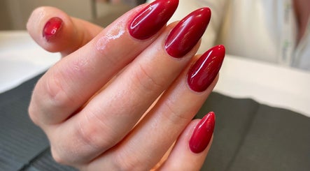 Elegant crimson nail art at Dolluxe Beauty, Aberdeen, Scotland, GB showcasing sophisticated manicure style.