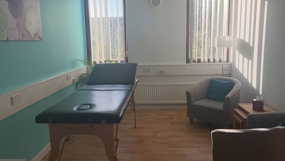 Massage room at Thyme to Unwind Therapies, Gloucester, England, GB, featuring calming decor and natural light.