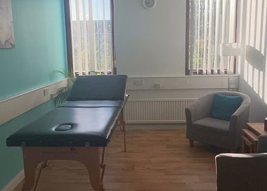 Massage room at Thyme to Unwind Therapies, Gloucester, England, GB, featuring calming decor and natural light.