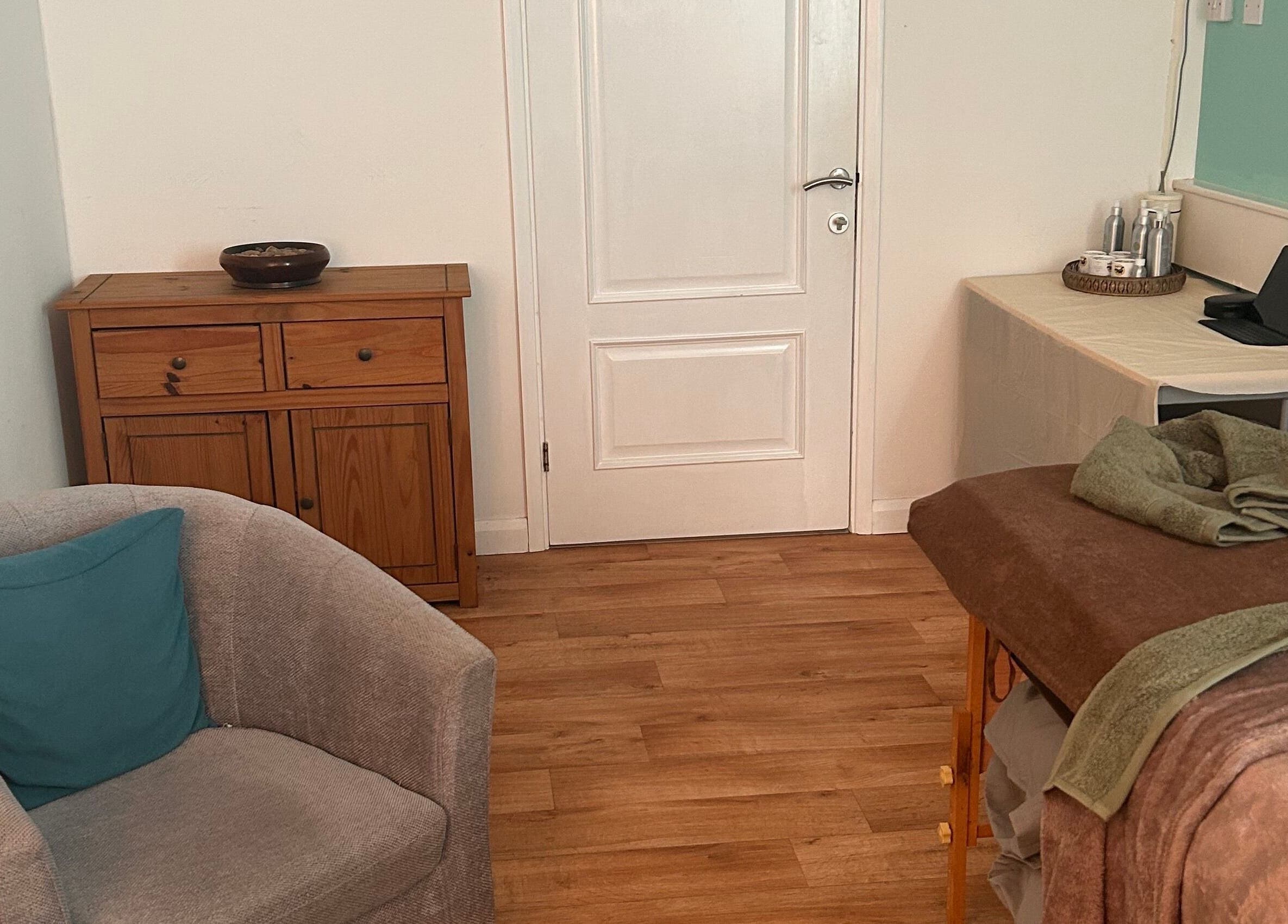 Relaxing therapy room at Thyme to Unwind Therapies in Gloucester, England, GB with cozy decor and treatment bed.