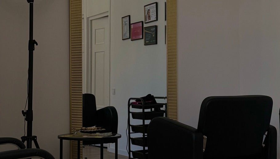 Modern salon interior at Inguna Chaman Hair Design, Rīga, LV, featuring chic seating and decor.