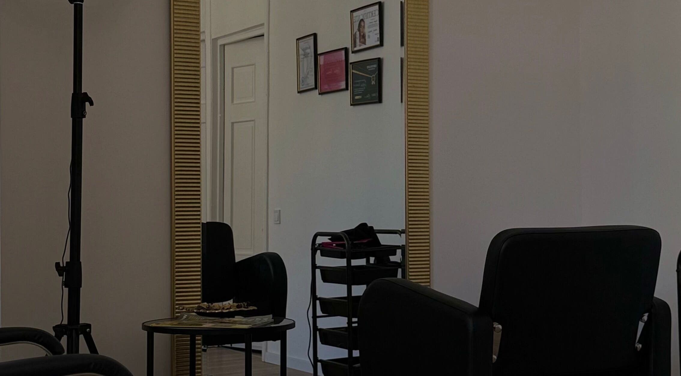 Modern salon interior at Inguna Chaman Hair Design, Rīga, LV, featuring chic seating and decor.