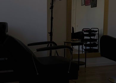 Elegantly designed hair salon at Inguna Chaman Hair Design in Rīga, LV with modern styling chairs and large mirror.
