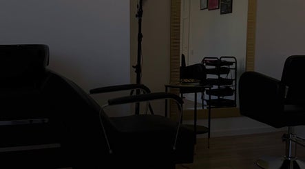 Elegantly designed hair salon at Inguna Chaman Hair Design in Rīga, LV with modern styling chairs and large mirror.