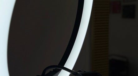 Elegant lighting setup at Inguna Chaman Hair Design, Rīga, LV, creating a serene salon ambiance.