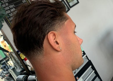 Profile view of a sleek tapered haircut at Haircut by Ronii_moo, Bali, Bali, ID.