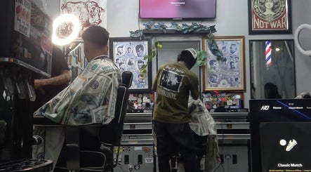 Client receiving a stylish haircut at Haircut by Ronii_moo, Bali, Bali, ID. Vibrant barber shop interior.
