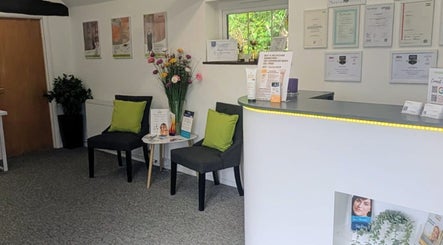 Reception area of Zoë-Erika Massage and Reiki, Haywards Heath, England, GB, with chairs and decor.