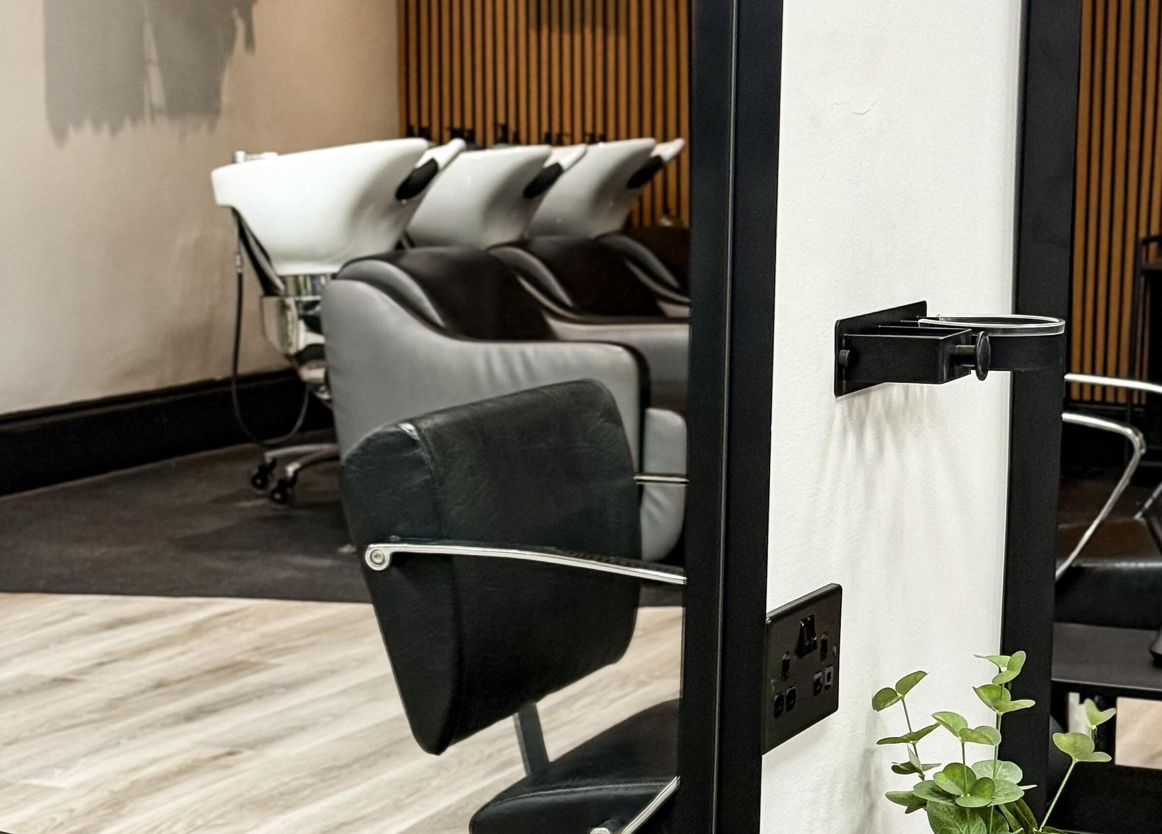Modern salon chairs and washing stations at LJ Hairdressing in Cowplain, England, GB.