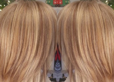 Blonde layered hair styled at Annabel Hair, Sandbach, England, GB with festive background.
