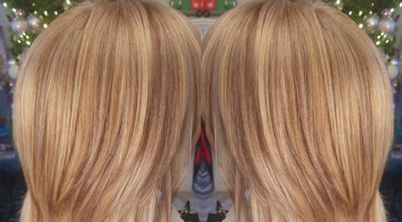Blonde layered hair styled at Annabel Hair, Sandbach, England, GB with festive background.