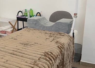 Luxurious massage bed at Glow By Miriam, Bragança, Bragança, PT, featuring plush blanket and towels.