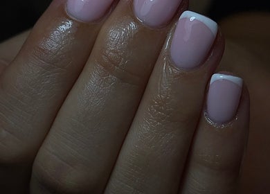 Close-up of elegant French manicure at ER nails, Worsley, England, GB. Perfectly polished with classic white tip.