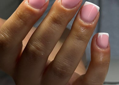 Stylish French manicure at ER nails, Worsley, England, GB, showcasing pink and white nail design.