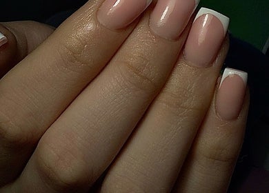 Elegant French manicure at ER nails, Worsley, England, GB showcasing flawless nail art.