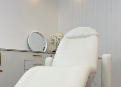 Relaxing treatment room at The Orielle Clinic (Edinburgh), Edinburgh, Scotland, GB with a plush white chair.