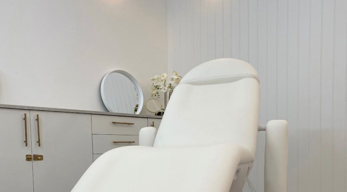Relaxing treatment room at The Orielle Clinic (Edinburgh), Edinburgh, Scotland, GB with a plush white chair.