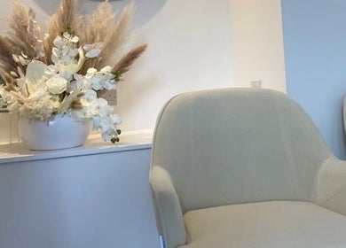 Comfortable seating at The Orielle Clinic (Edinburgh), adorned with elegant floral arrangement, Edinburgh, Scotland, GB.