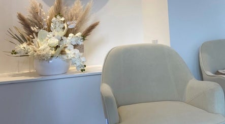 Comfortable seating at The Orielle Clinic (Edinburgh), adorned with elegant floral arrangement, Edinburgh, Scotland, GB.