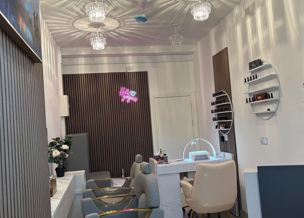 Chic and modern interior of Nail & Brow Bar Mullingar, Mullingar, IE, showcasing manicure stations and nail polish display.