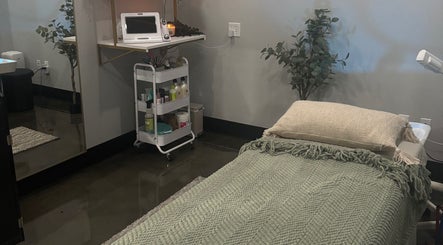 Tranquil treatment room at Bright & Blissful, Brunswick, Georgia, US. Cozy bed with soft lighting and decor.