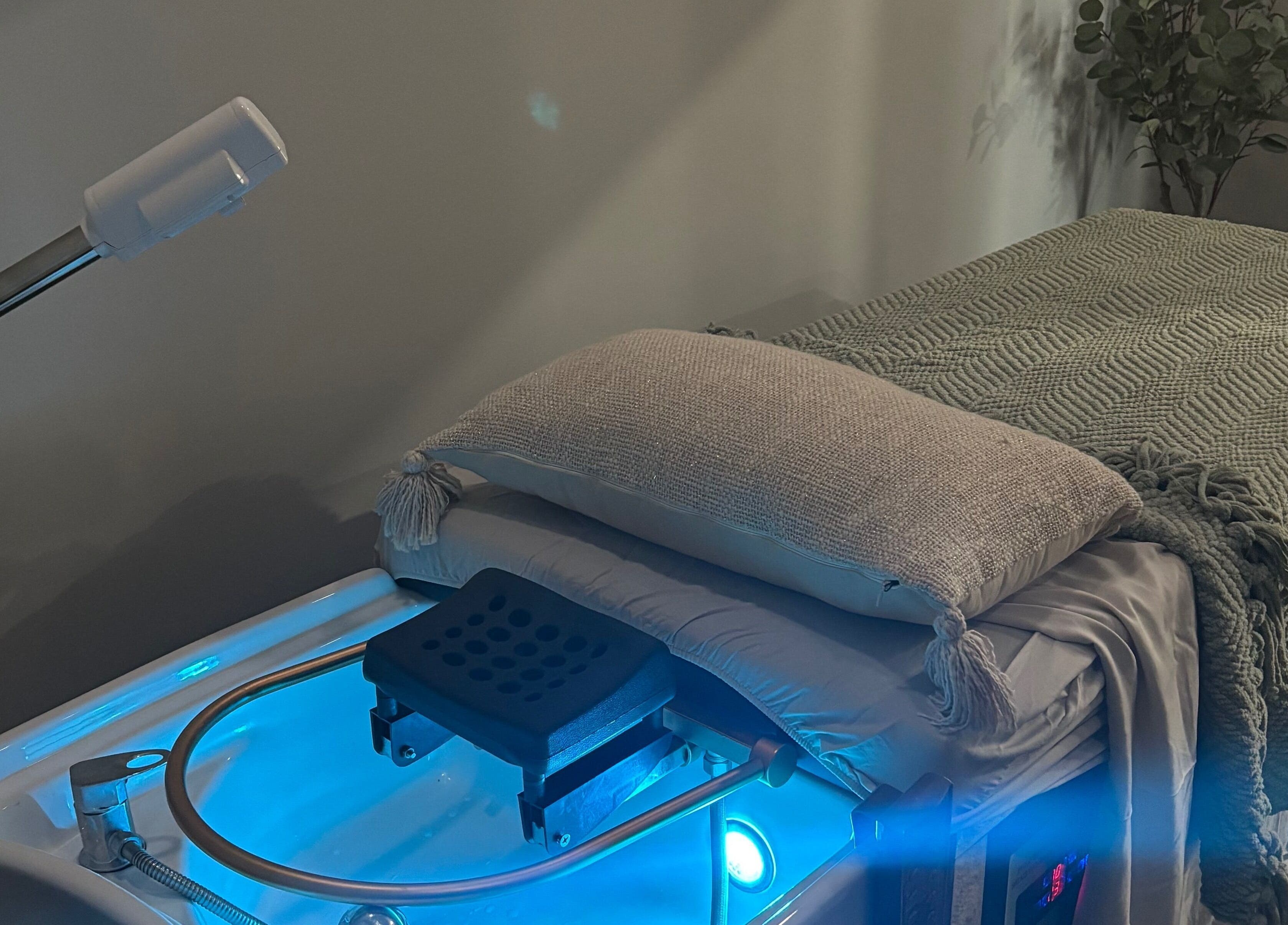 Calming spa treatment room at Bright & Blissful, Brunswick, Georgia, US with a massage table and ambient lighting.