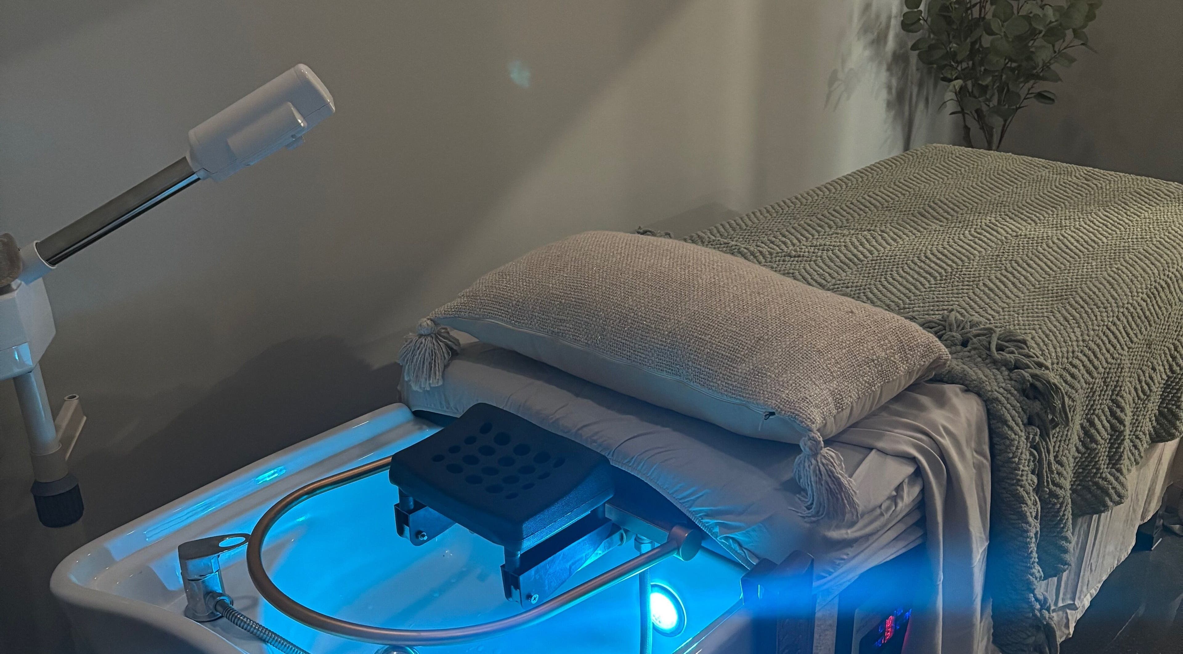 Calming spa treatment room at Bright & Blissful, Brunswick, Georgia, US with a massage table and ambient lighting.