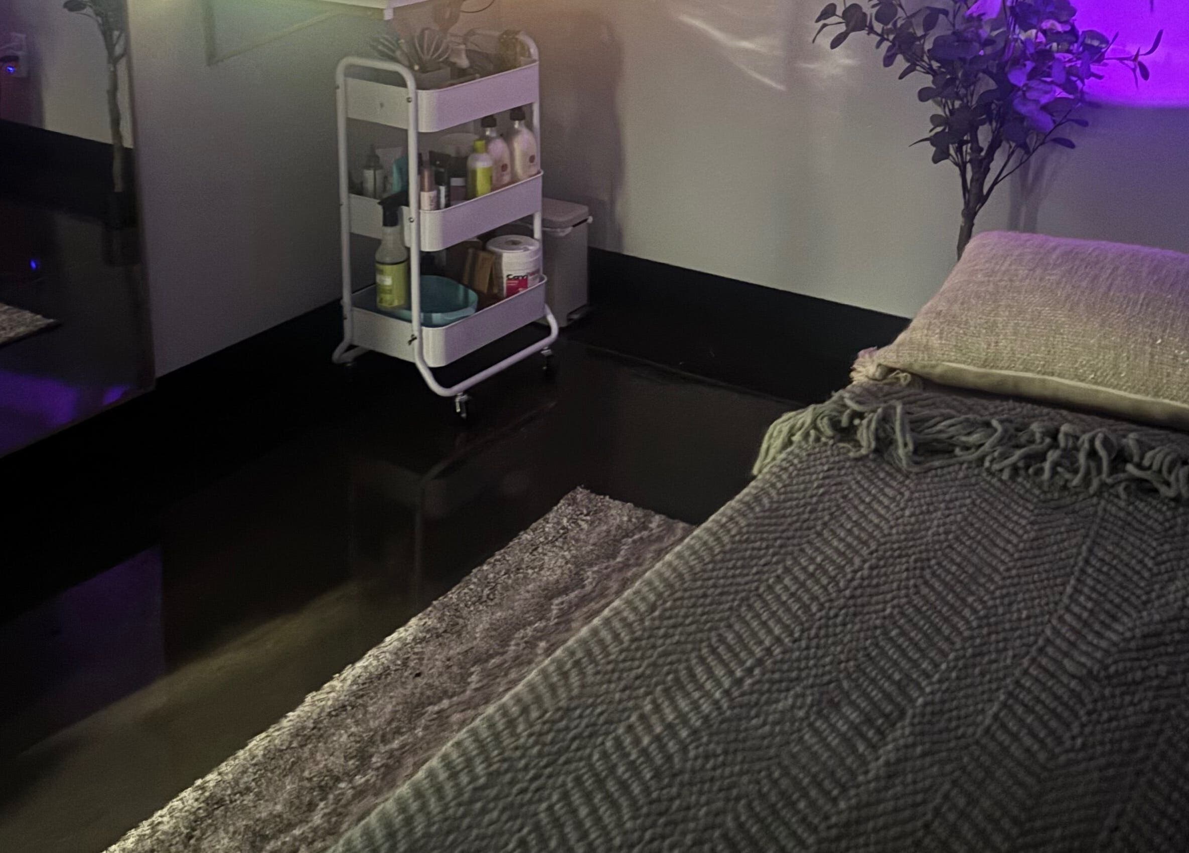 Cozy wellness room at Bright & Blissful, Brunswick, Georgia, US with a treatment bed and ambient lighting.