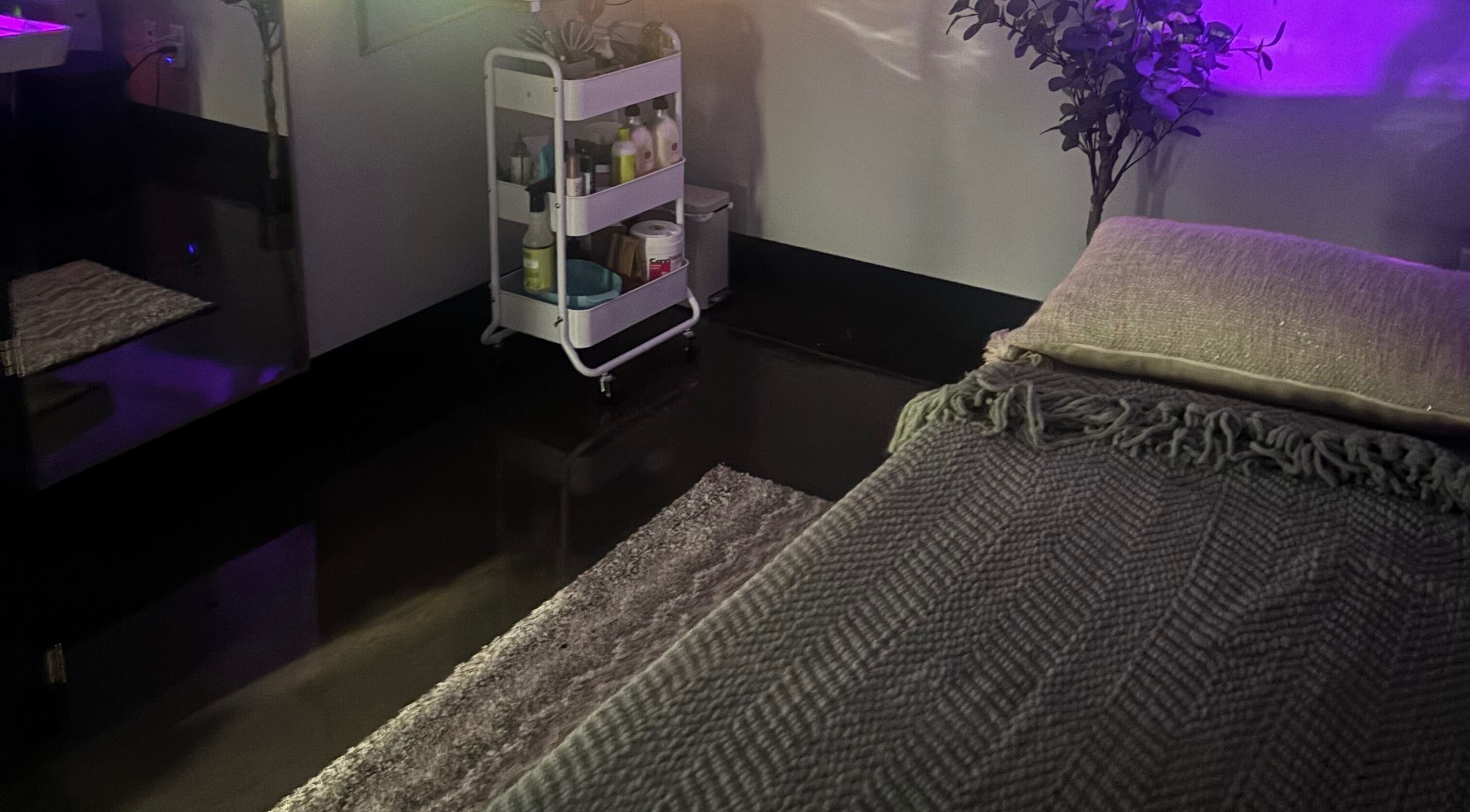 Cozy wellness room at Bright & Blissful, Brunswick, Georgia, US with a treatment bed and ambient lighting.