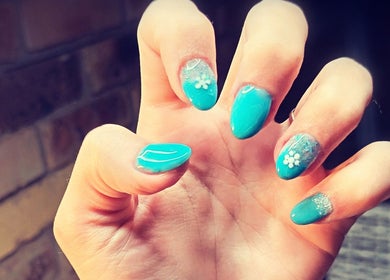 Turquoise nail art with floral designs at Cute-Icles, Boksburg, Gauteng, ZA, showcasing elegance.