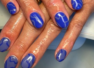 Blue wave nail art design at Daisie Mae Beauty in Lechlade, England, GB, showcasing glossy style.