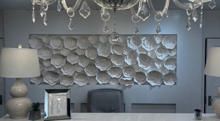 Elegant reception area at Lash Studio, Barnstable, Massachusetts, US, featuring intricate rose wall art.