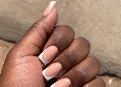 Elegant French manicure at August Nails, Lusaka, Lusaka Province, ZM. Perfectly groomed nails with a chic style.