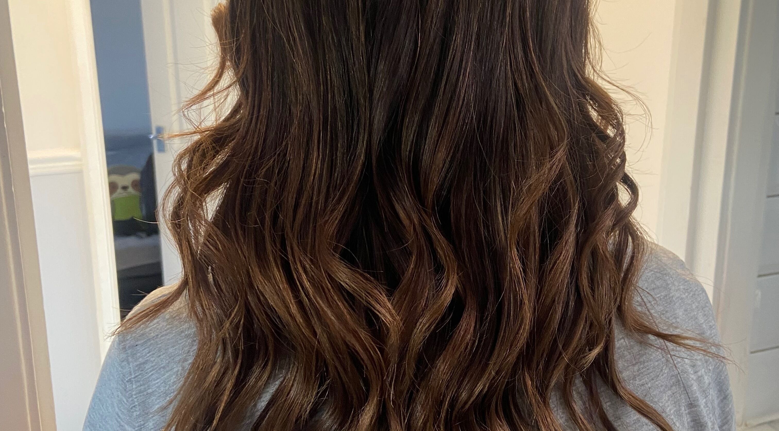 Brunette wavy hairstyle at Linda Hairstylists, Corby, England, GB showcasing expertly styled curls.