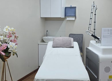 Κομψό δωμάτιο θεραπείας στο Mandarinlaser_aesthetics στη Λεμεσό, Λεμεσό, CY με κρεβάτι και εξοπλισμό αισθητικής.