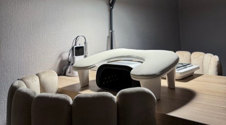 Cozy manicure station at Pretty Little Nails, Reigate, England, GB with plush chairs and nail equipment.