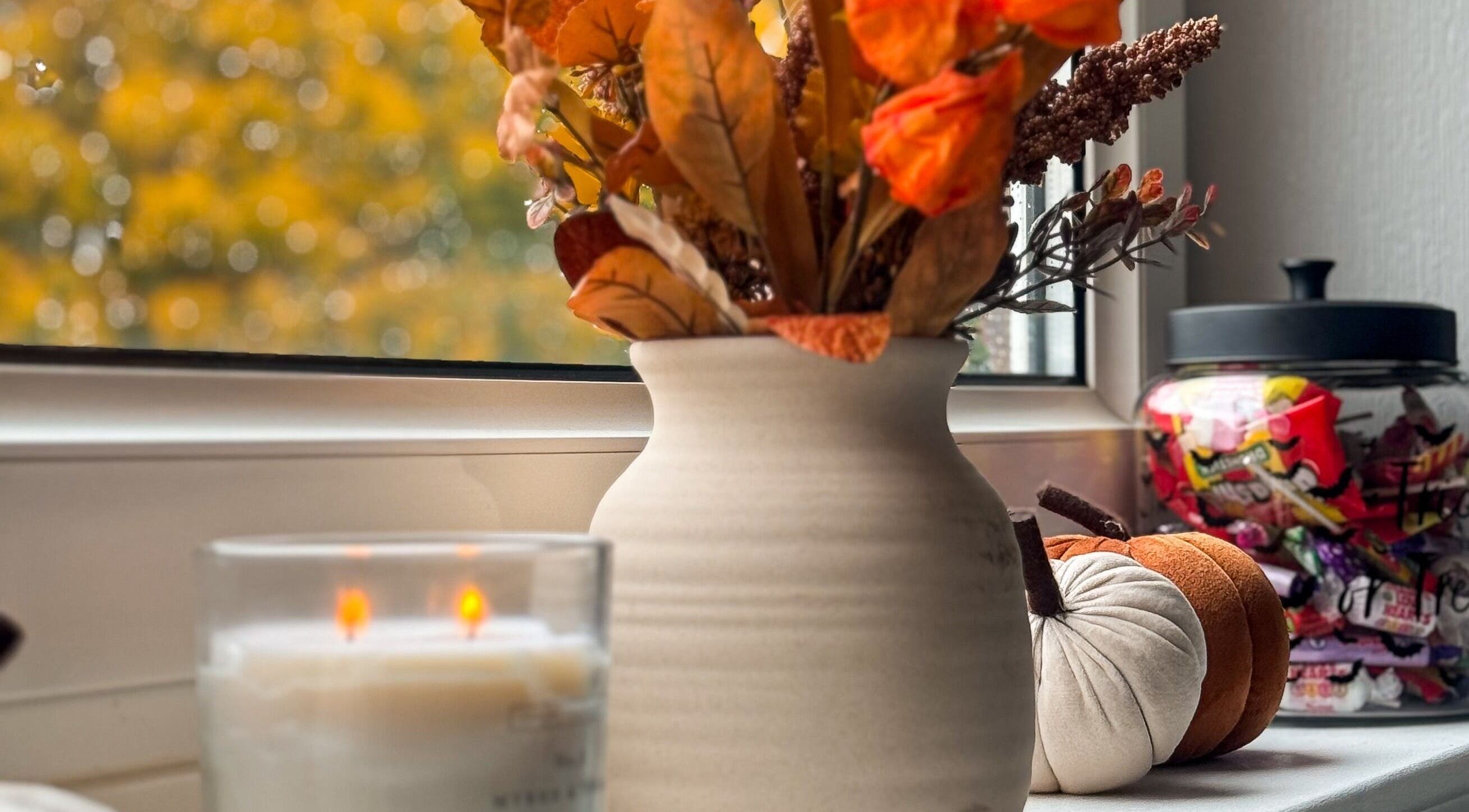Autumn decor at Pretty Little Nails, Reigate, England, GB, featuring a vase, candle, and candies.