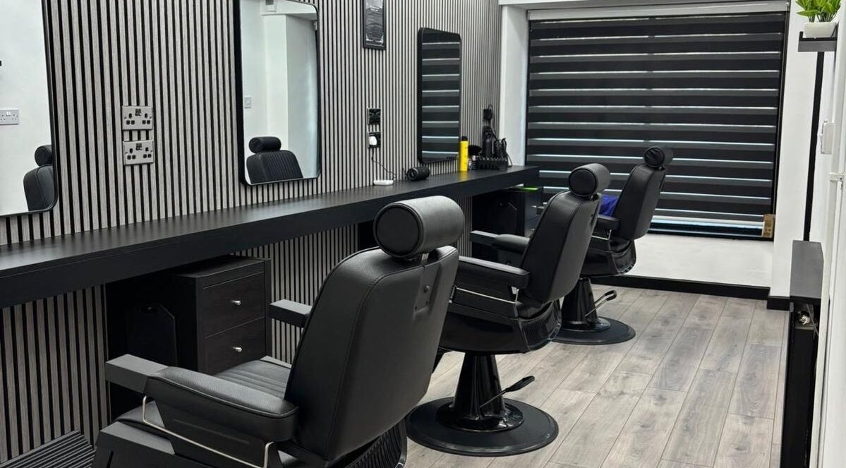Modern barber chairs at Ignite Barbershop, Tetbury, England, GB in a chic, contemporary interior.